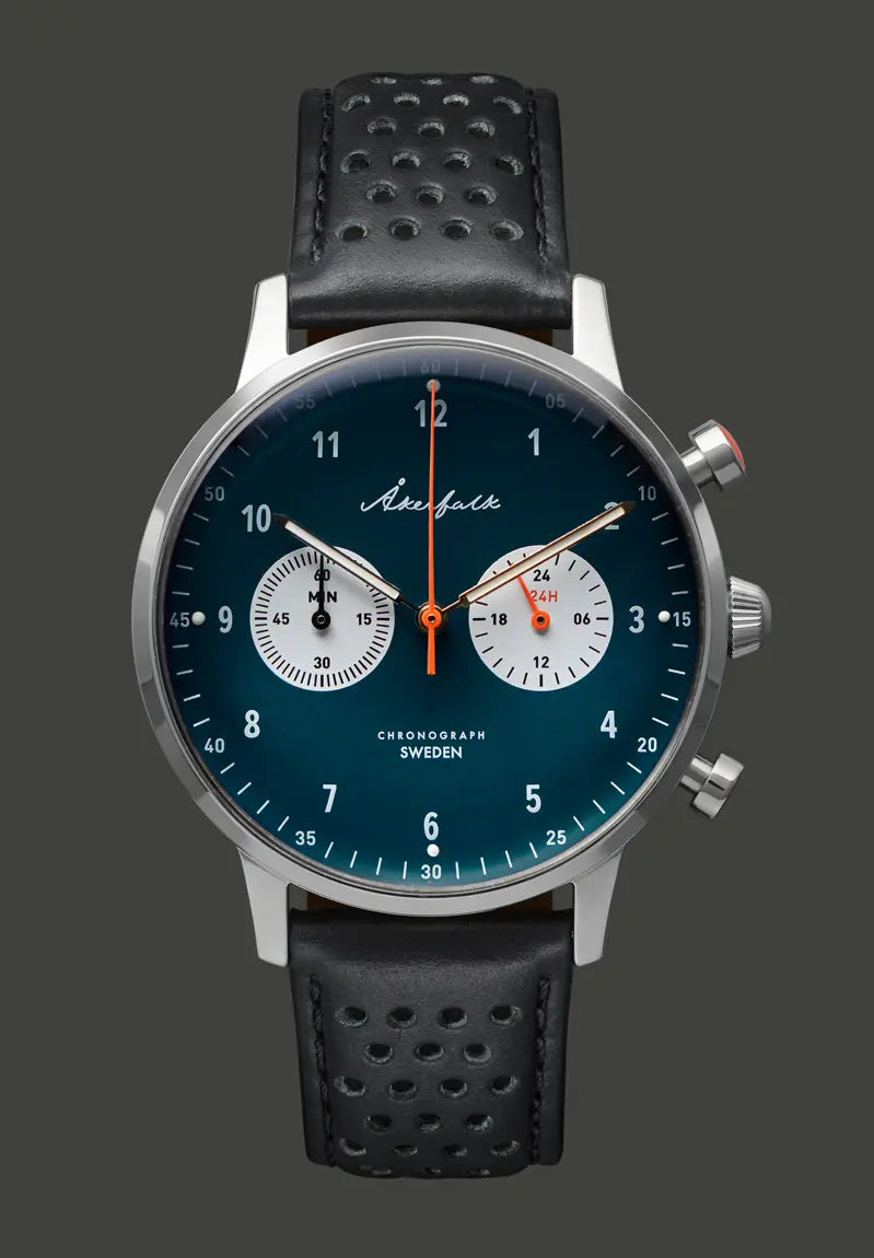 A silver Akerfalk chronograph watch with a blue dial and black leather strap, showing time and chronograph functions.