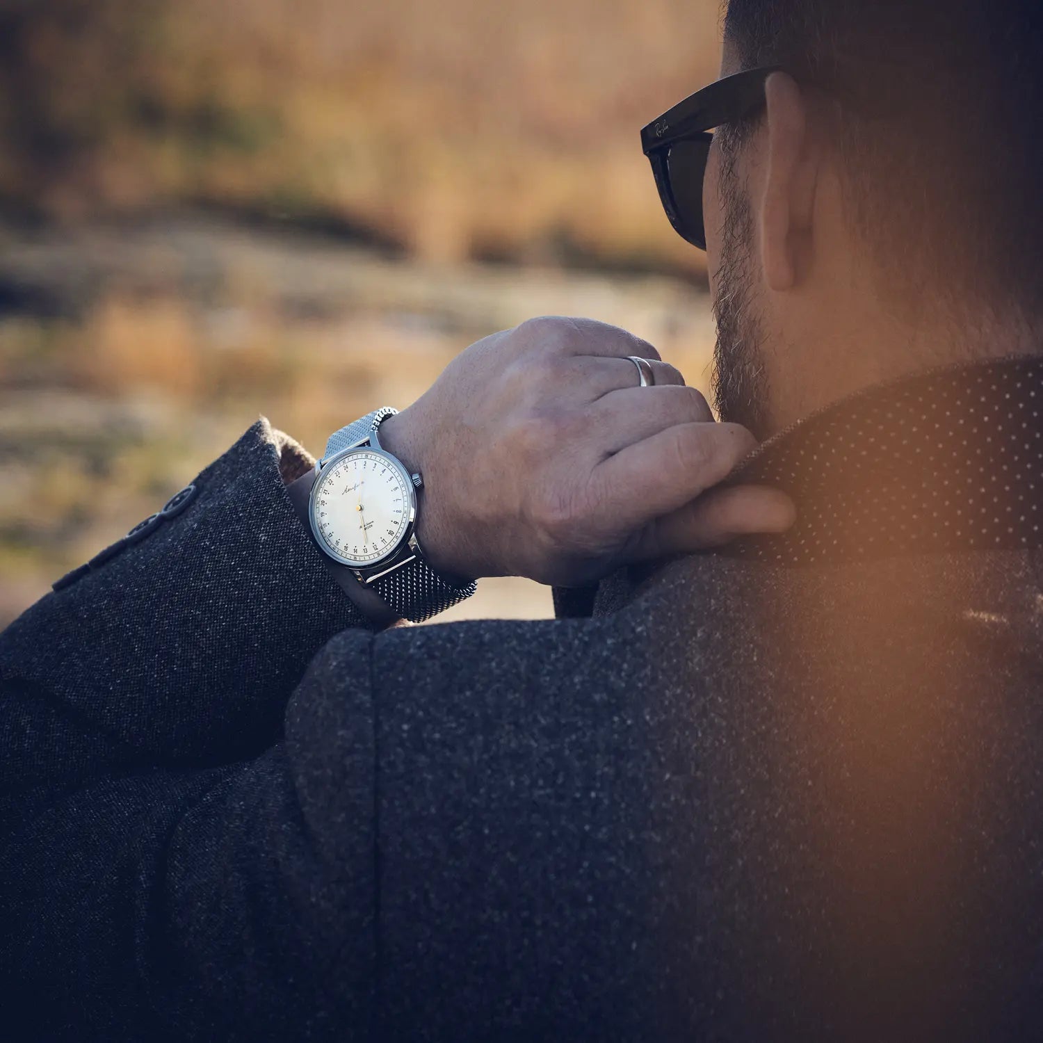 Akerfalk First season 24-hour watch with mesh strap worn by a man in blazer
